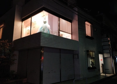 Beautiful white tiled buildings reflect the shop lights in Jingumae, Tokyo